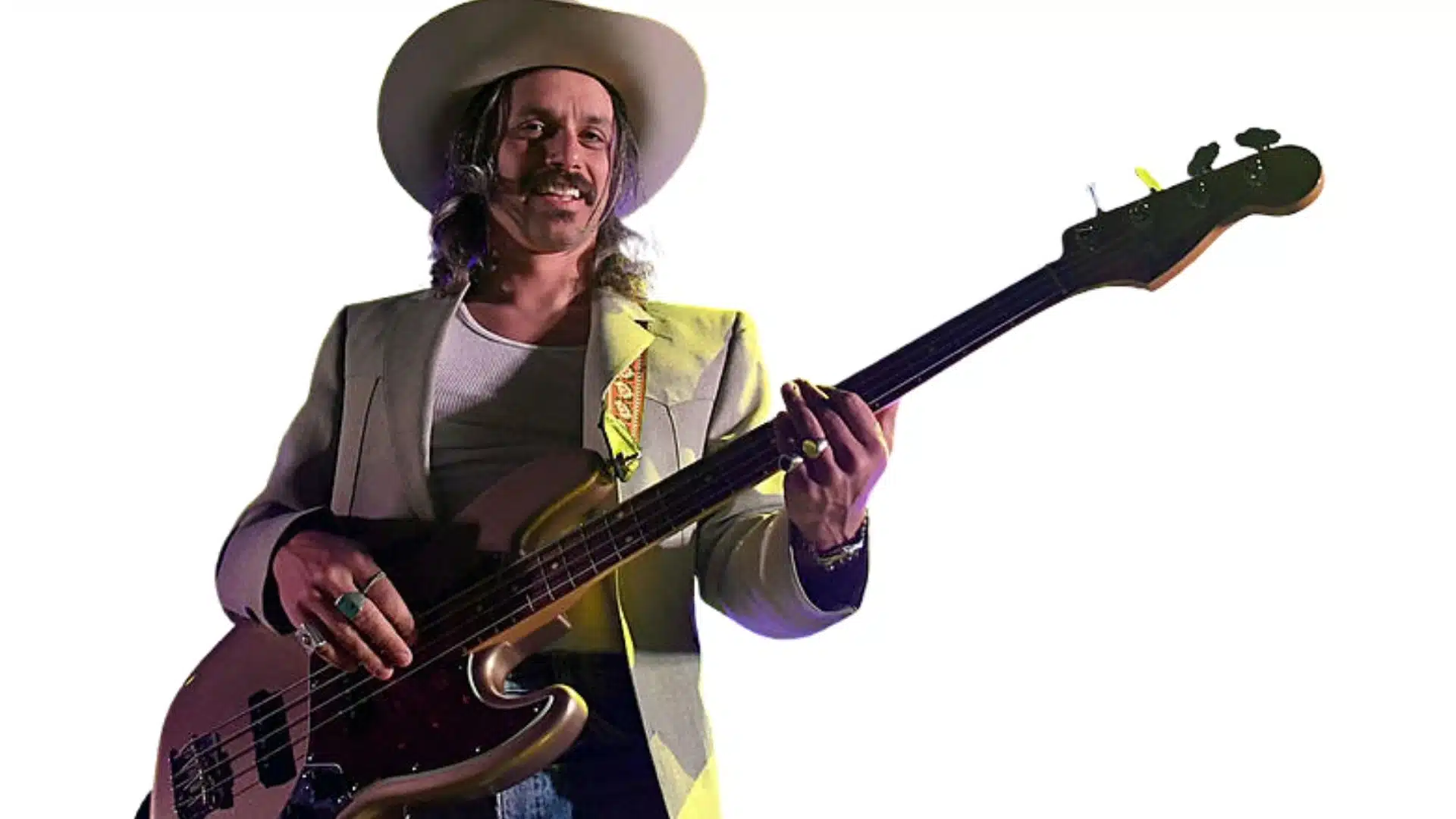 Midland bassist Cameron Duddy playing a sunburst bass guitar while wearing a wide-brimmed cowboy hat.