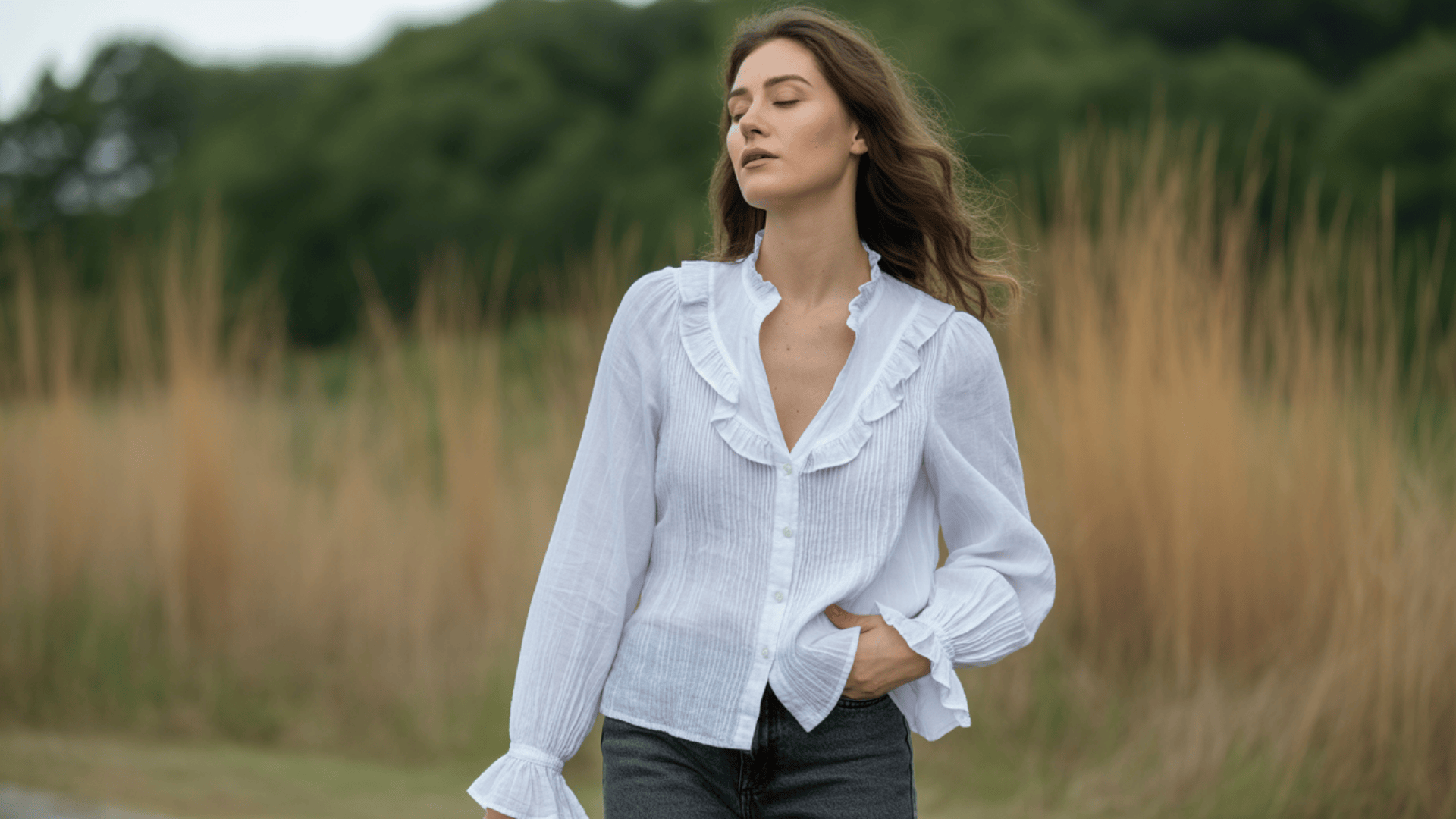 Button-up blouse with soft ruffle detailing styled casually outdoors in a natural setting