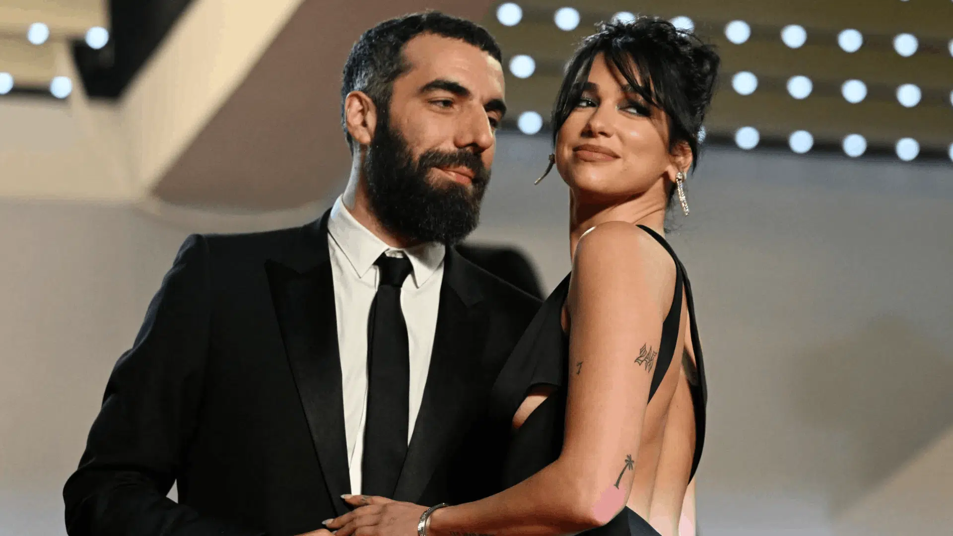 Dua Lipa with filmmaker Romain Gavras at a red carpet event.