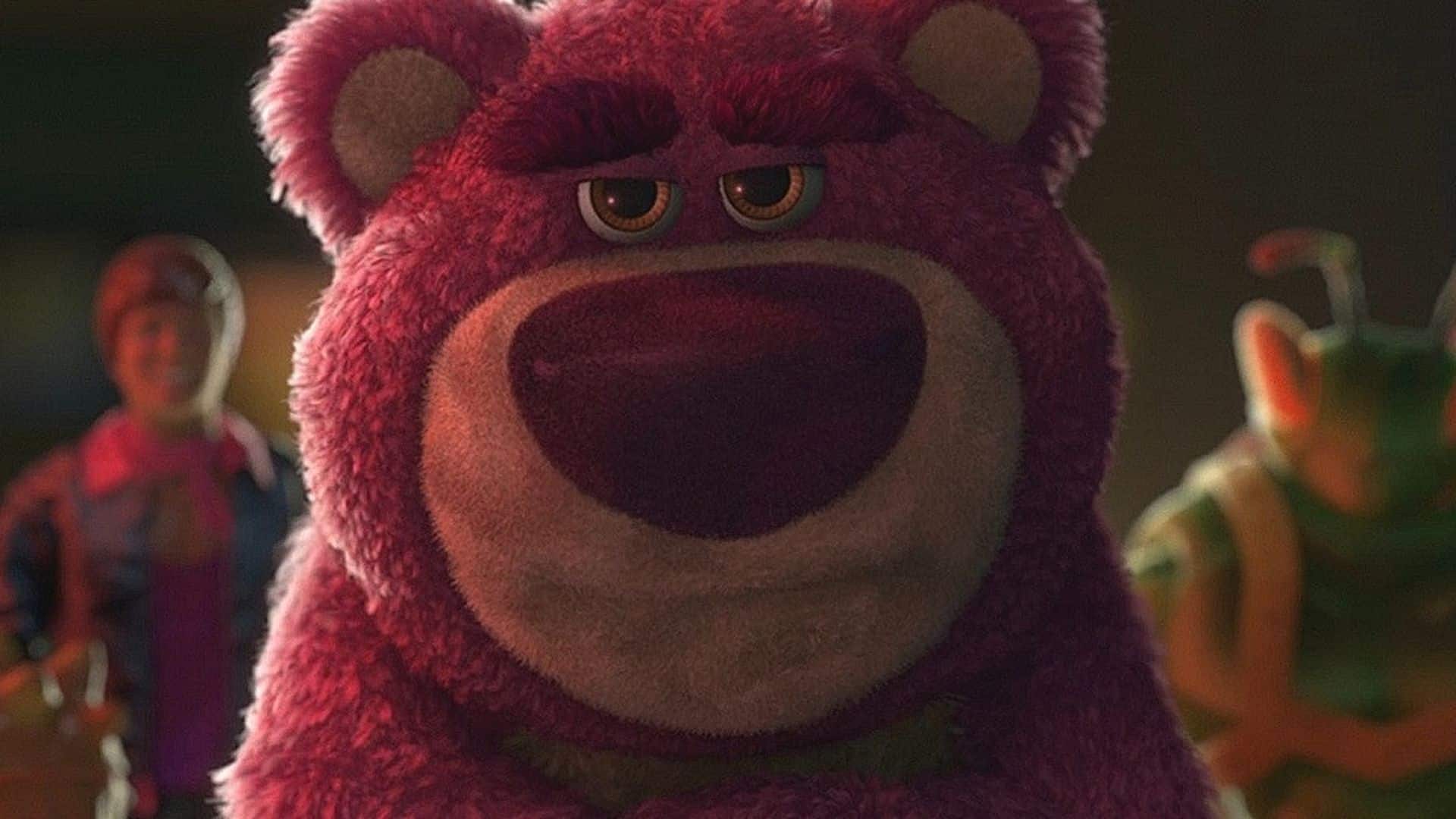 Lotso, the pink teddy bear villain from Toy Story 3, staring ahead with a stern expression while Woody and Buzz appear blurred in the background.