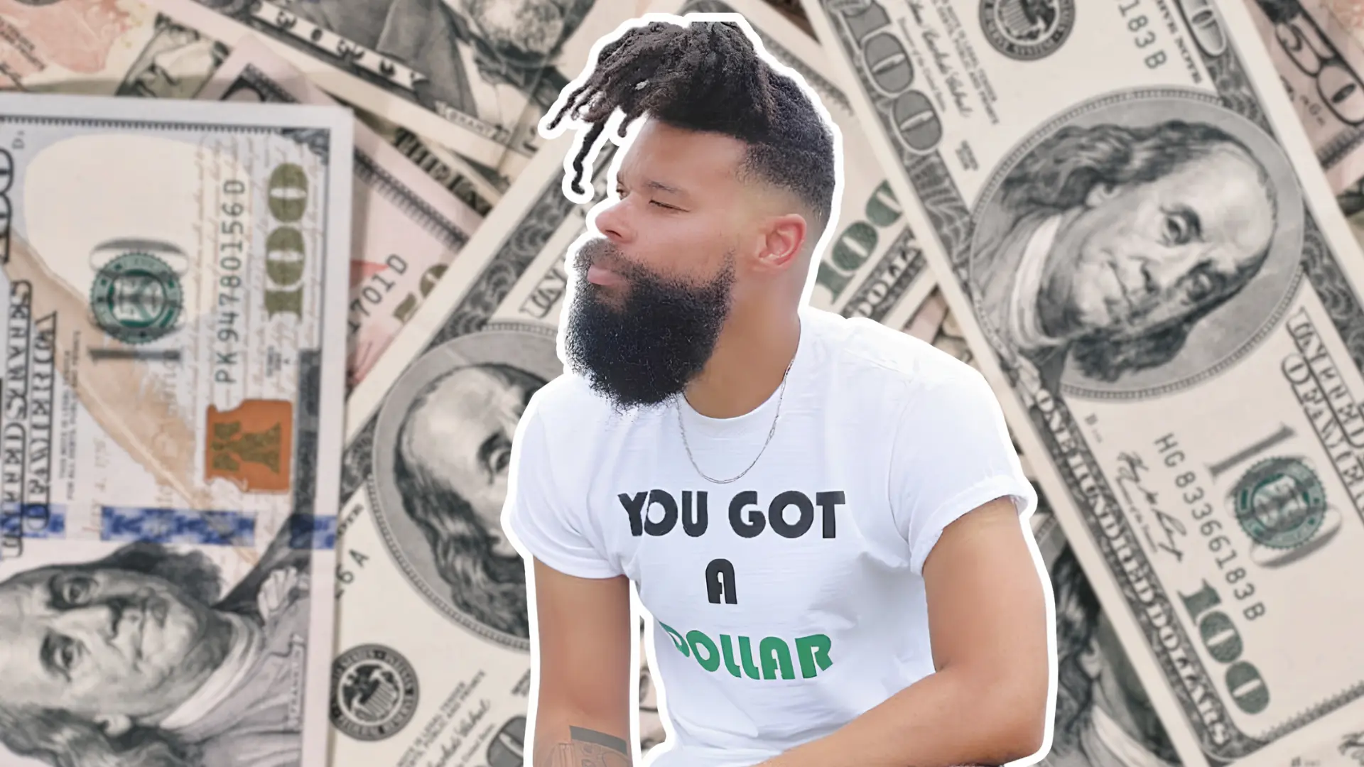 Damon Darling wearing his You Got a Dollar branded shirt against a background of hundred dollar bills.